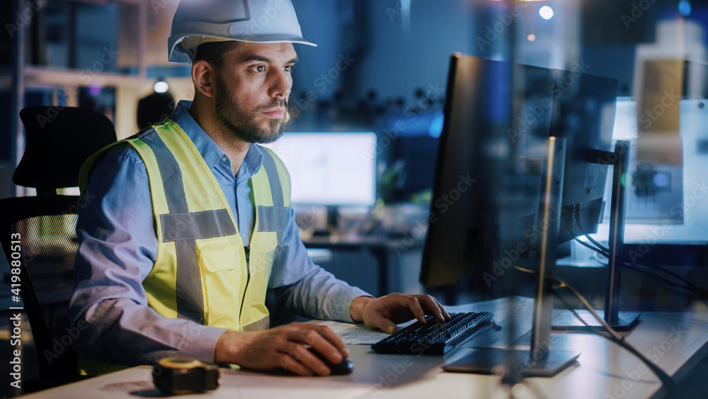 Poster electronics design factory: portrait of handsome male engineer wearing safety vest working on comput