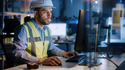 Electronics Design Factory: Portrait of Handsome Male Engineer Wearing Safety Vest Working on Computer, Developing Industrial Microchips, Semiconductor, Manufacturing Processors.