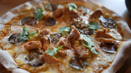 Close up of meat pizza topping with chicken mushroom and cheese at restuarant 