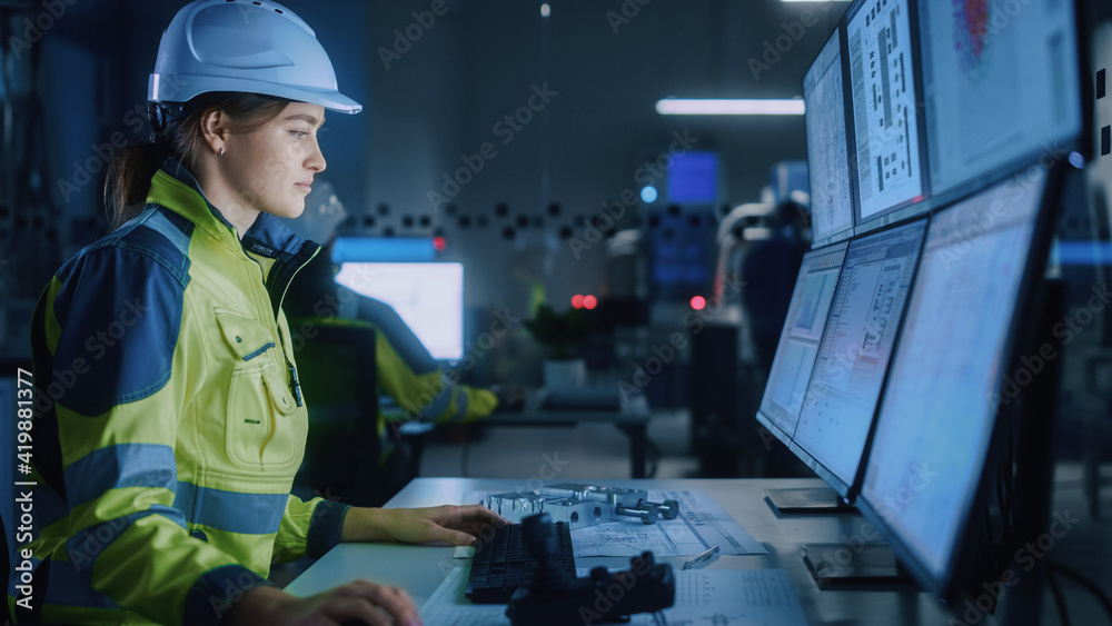 Leinwandbilder Industry 4.0 Modern Factory: Female Facility Operator Controls Workshop Production Line, Uses Computer with Screens Showing Complex UI of Machine Operation Processes, Controllers, Machinery Blueprints
