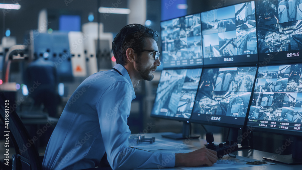 Poster Industry 4.0 Modern Factory: Security Operator Controls Proper Functioning of Workshop Production Line, Uses Computer with Screens Showing Surveillance Camera Feed. High-Tech Security