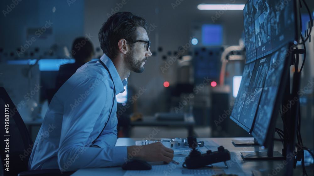 Poster Industry 4.0 Modern Factory: Security Operator Controls Proper Functioning of Workshop Production Line, Uses Computer with Screens Showing Surveillance Camera Feed. High-Tech Security