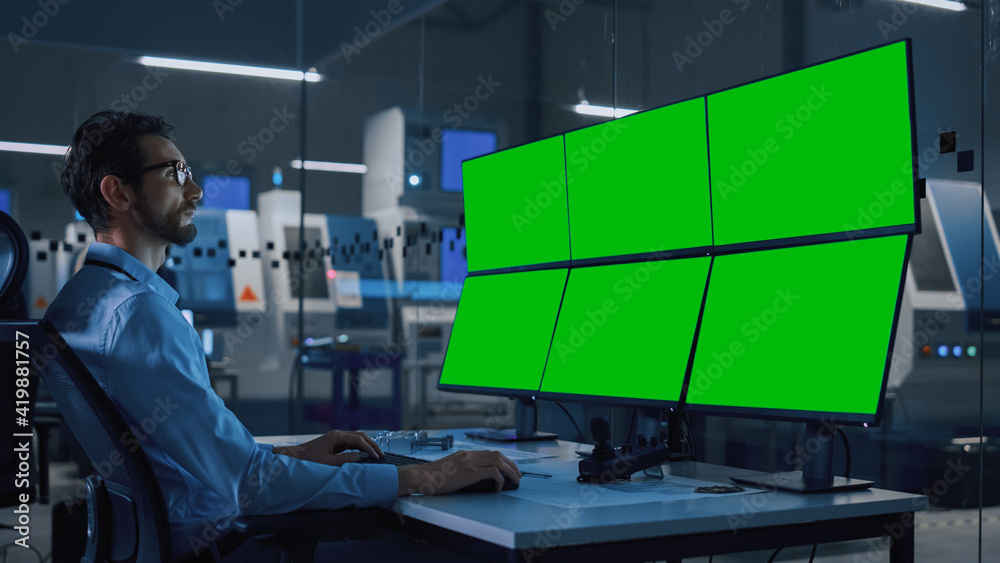 Poster Industry 4.0 Modern Factory: Security Operator Controls Proper Functioning of Workshop Production Line, Uses Computer with 6 Screens Showing Green Screen Mock up Template.
