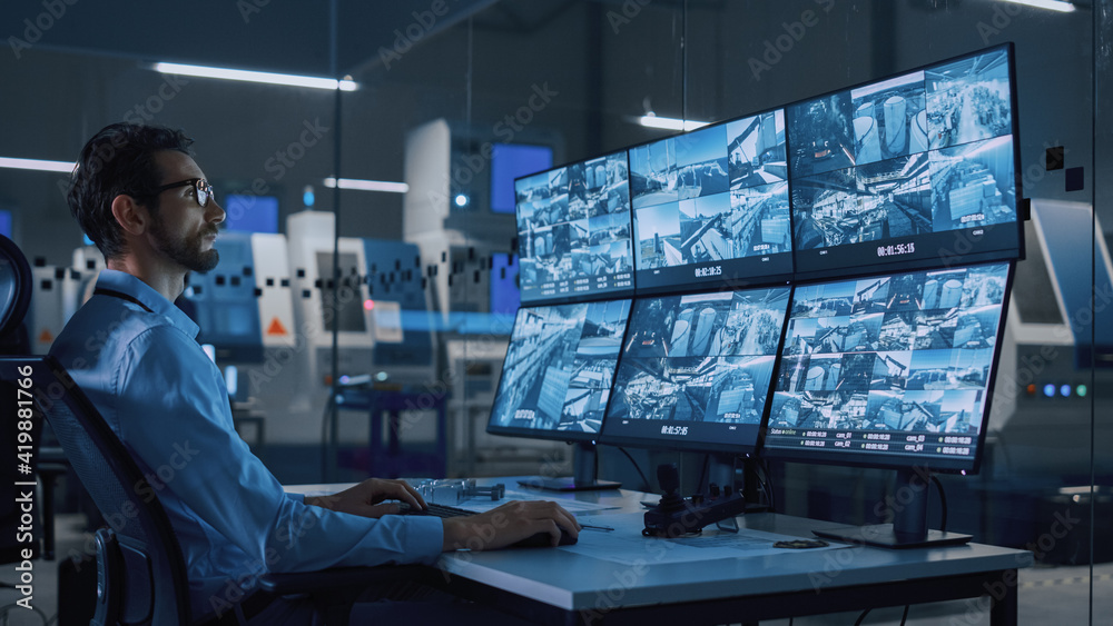 Poster Industry 4.0 Modern Factory: Security Operator Controls Proper Functioning of Workshop Production Line, Uses Computer with Screens Showing Surveillance Camera Feed. High-Tech Security