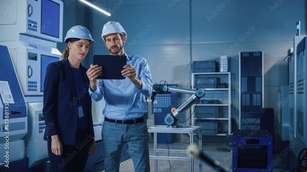 Poster Portrait of Two Professional Engineers Use Industrial Digital Tablet to Work with Augmented Reality. Great Template Shot for Augmented Reality. Factory Workshop with CNC Machinery.