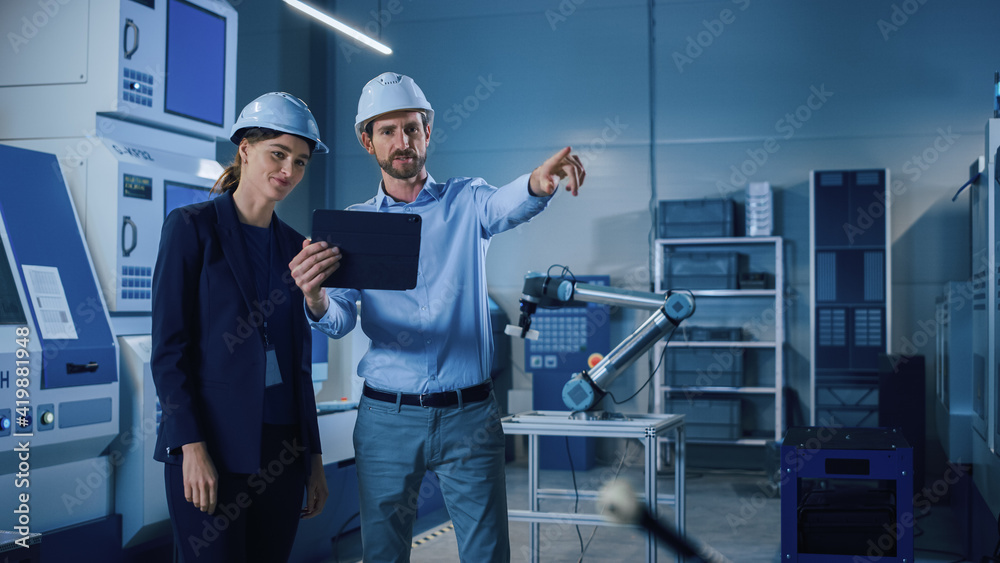 Poster Portrait of Two Professional Engineers Use Industrial Digital Tablet to Work with Augmented Reality. Great Template Shot for Augmented Reality. Factory Workshop with CNC Machinery.