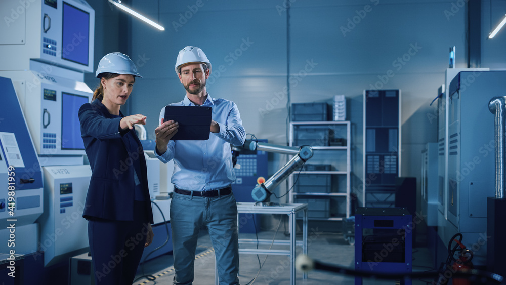 Poster Portrait of Two Professional Engineers Use Industrial Digital Tablet to Work with Augmented Reality. Great Template Shot for Augmented Reality. Factory Workshop with CNC Machinery.