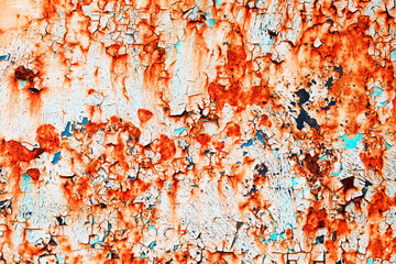 Bright textured weathered grunge background for your design. Rusty metal surface cracked with peeling old blue and red paint.