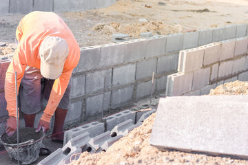Workers are laying blocks of bricks.