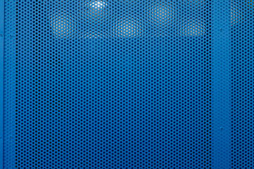 Urban background. Perforated metal sheet with rivets.