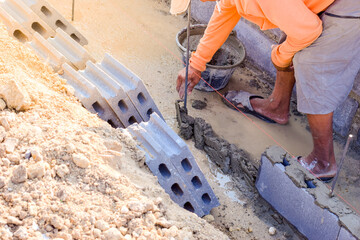 Workers are laying blocks of bricks.