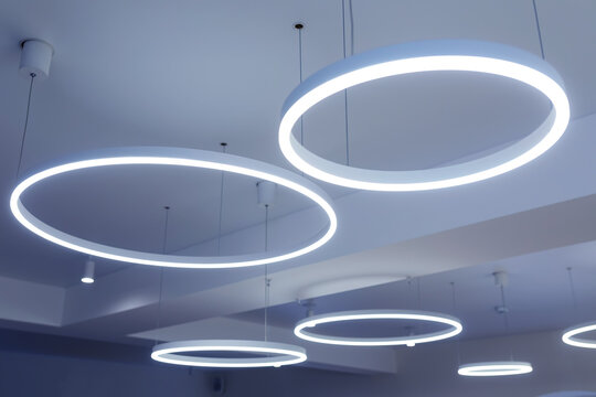 Ceiling with round modern LED lamps. Suspended fluorescent lights under the ceiling. Careful energy consumption, energy saving concept
