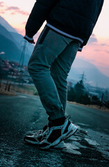 Pair of legs on the cold mountain sunrise