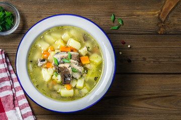  Hearty homemade soup, ukha, fish soup on wooden rustic background. Space for text, top view.