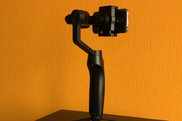 Handheld 3-axis gimbal with a smartphone - obrazy, fototapety, plakaty