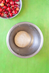 CHerry pie in the making: crust pie and filled whit red cherries