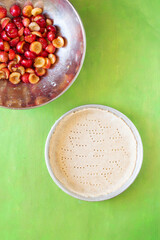 CHerry pie in the making: crust pie and filled whit red cherries