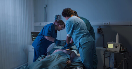 Medical team making cardiopulmonary resuscitation to male patient in hospital