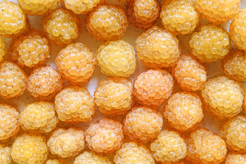  Background from ripe berries of  yellow raspberry. Top view. Pattern..