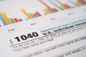 Obraz premium Bangkok, Thailand - June 1, 2020 Tax Return form 1040 and dollar banknote, U.S. Individual Income.