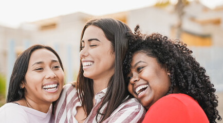 Happy multiracial women hugging each other - Girls with different skin colors - Friendship and happiness concept - obrazy, fototapety, plakaty