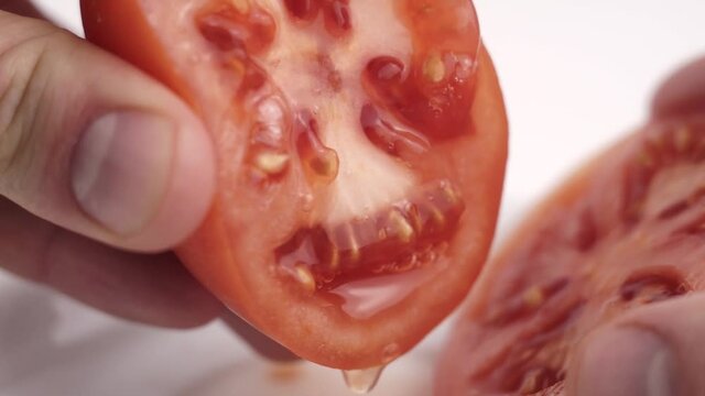 squeeze the juice from half a tomato with your hand