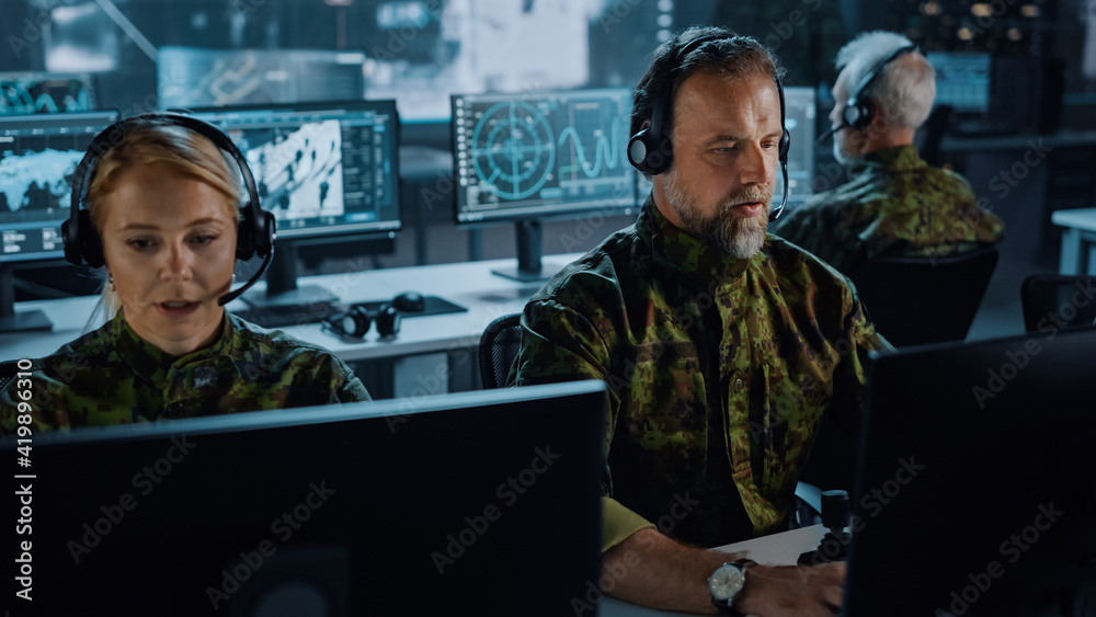 Leinwandbilder Military Surveillance Team of Officers in Headsets Working in a Central Office Hub for Cyber Operations, Control and Monitoring for Managing National Security, Technology and Army Communications.