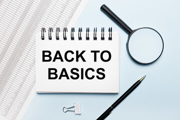 On a blue background, reports, a magnifying glass, a pen and a notebook with the text BACK TO...
