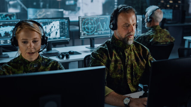 Military Surveillance Team Of Officers In Headsets Working In A Central Office Hub For Cyber Operations, Control And Monitoring For Managing National Security, Technology And Army Communications.