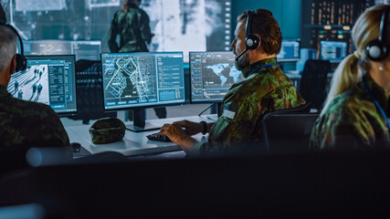 Military Surveillance Officer Working on a City Tracking Operation in a Central Office Hub for...