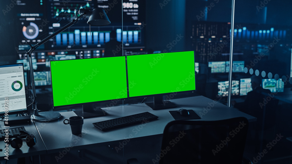 Aufkleber Two Digital Computer Screens with a Green Mock Up Chromakey in Modern Monitoring Office. Control Room with Specialists and Managers Sit in Front of Computers. 