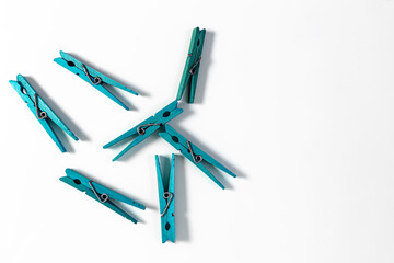 Blue wooden clothespins on a white background. Concept. High quality photo