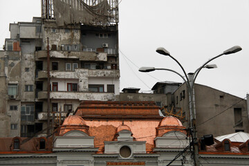Fototapeta premium A run-down building next to a nice building in Bucharest Romania 