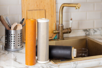 Old filter cartridges for cleaning tap water in the kitchen