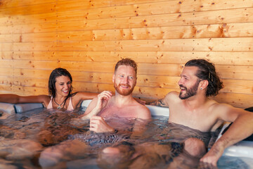 Friends relaxing in a spa center hot tub