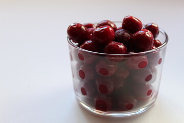 food berries frozen red burgundy cherries in a glass glass on a white background with a place for text and a copyspays close-up view from the side from top of 45 degrees