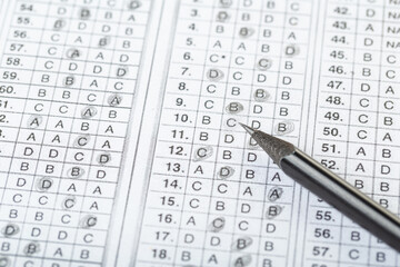 testing in exercise and exam paper. computer sheet with pencil in school test room, education concept. filling in answers in pencil