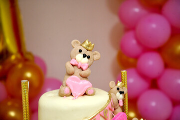 baby girl birthday cake with cute teddy bear figurines
