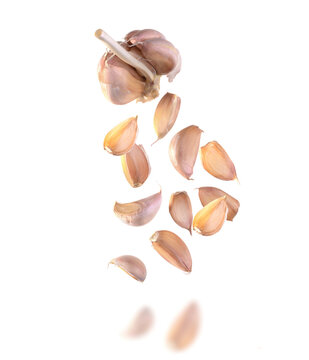 falling garlic onion and garlic cloves isolated on a white background