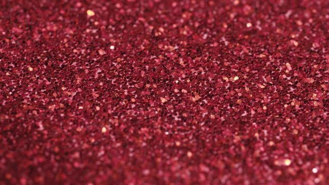 Macro slide shot, small red sequins, shimmer in the light