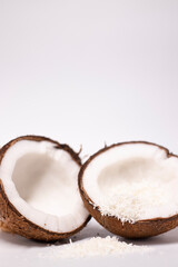 opened coconut with coconut flakes isolated on white background. tropical, nut
