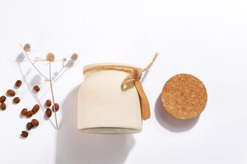 Organic craft soy candle with label, dry flower and coffee beans on white background