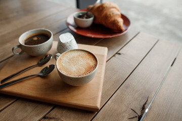 cup of fragrant coffee and delicious croissant with chocolate for breakfast