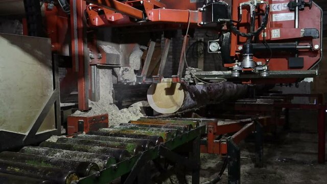 sawing logs into boards and beams on the sawmill