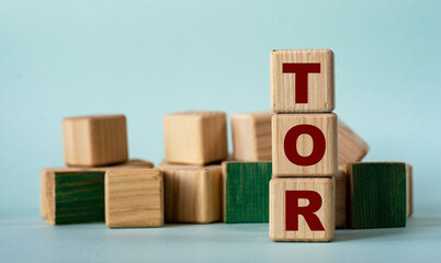TOR - acronym on wooden cubes on a background of colored block on a light background