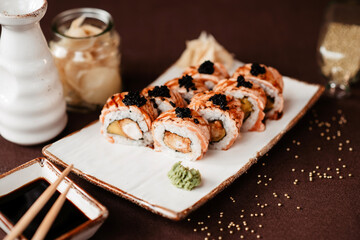 Sushi set with black caviar and eel, poured with soy sauce and