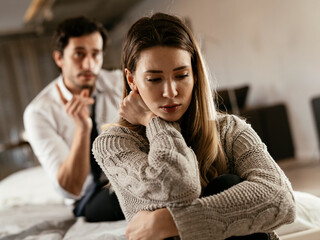 Husband and wife are arguing at home. Angry man is yelling at his wife.