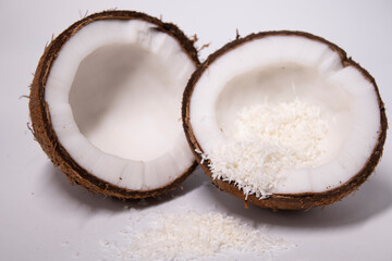 opened coconut with coconut flakes isolated on white background. tropical, nut