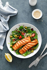 Grilled salmon fillet and fresh vegetable salad. Mediterranean diet.