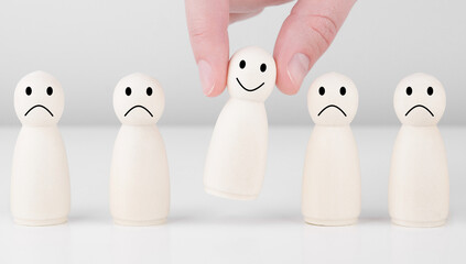 Wooden man with icons showing emotions and scores. Excellent business rating. Concept of satisfaction survey and customer services experience.